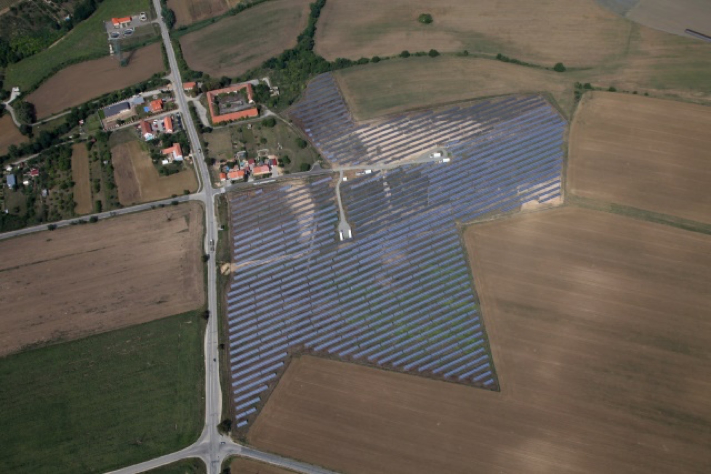 Aerial view of a completed ADI solar park in a rural landscape