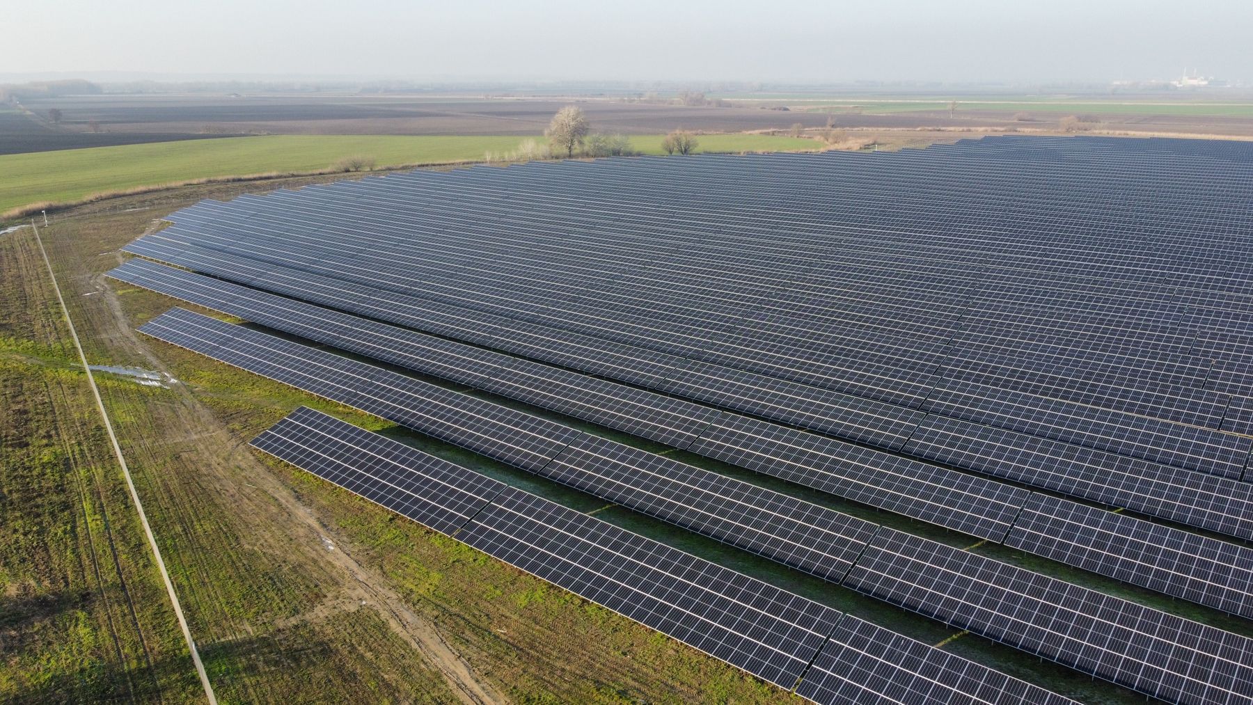 Aerial view of solar arrays in a rural landscape