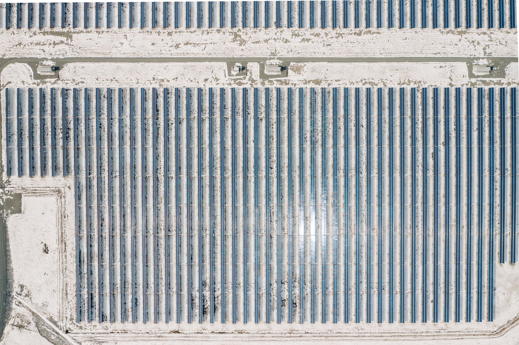 Aerial view of solar arrays in a winter landscape